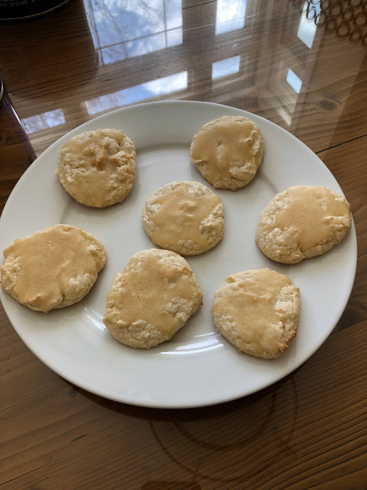 Buttery glazed cake mix cookies with shiny butter glaze on a white plate