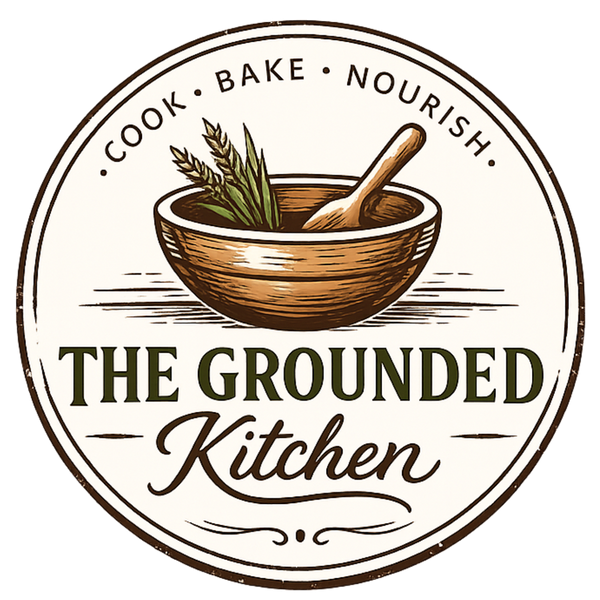 Logo of 'The Grounded Kitchen' with a wooden bowl and spoon on a white background